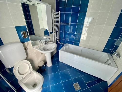 
a bathroom with a toilet a sink and a bathtub at Villa Boho Cherga in Belgrade
