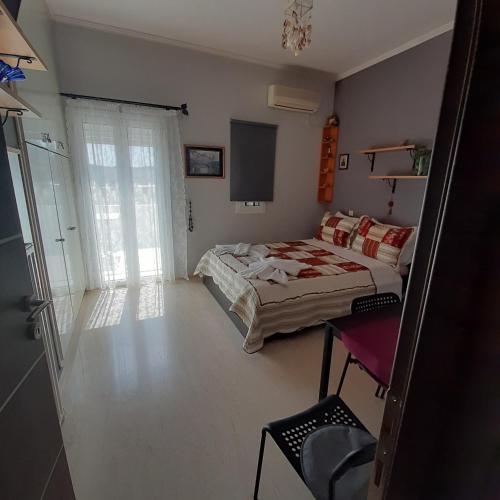 a bedroom with a bed and a television in it at Anatoli Studios in Áyios Fokás