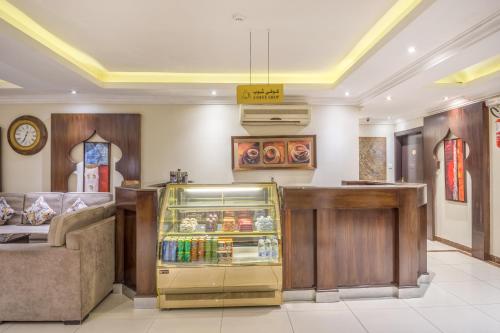 a restaurant with a drink cooler in a room at Dar Neyyara Apartments Furnished in Riyadh