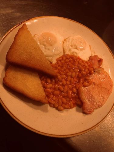 a plate of food with beans and eggs and meat at Slaters Country Inn in Whitmore