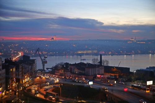a night view of a city with a river and buildings at Daru Sultan Hotels Galata in Istanbul