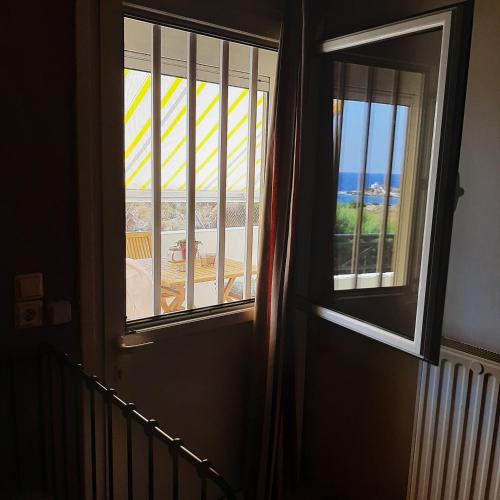 a room with a window with a view of the ocean at Anatoli Studios in Áyios Fokás