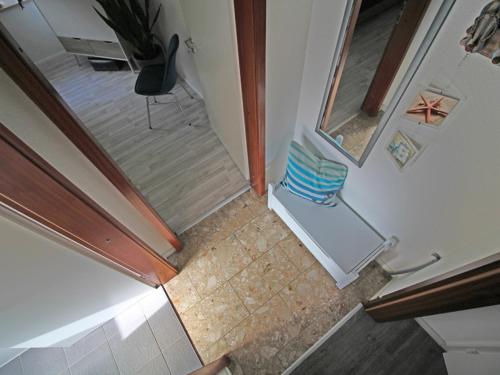 an overhead view of a room with a chair and a mirror at Möwennest am Ihlsee in Bad Segeberg