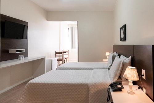 En eller flere senge i et værelse på Hotel Fabris
