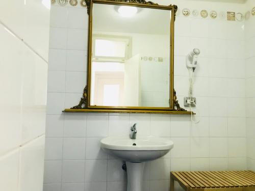 a bathroom with a sink and a mirror at Casa Tatillo - Immobilevante in Ponza