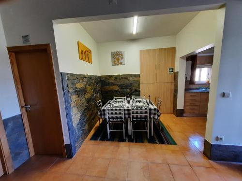 a dining room with a table and chairs in a room at Casa da Ruela no Rodo in Peso da Régua