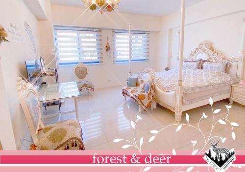 a bedroom with a bed and a table and a desk at Forest Deer Black Tea Homestay in Tainan