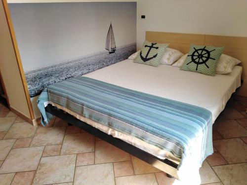 a bedroom with a large white bed with pillows at Guesthouse ROCK & ROLL in Rovinj