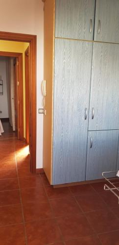 a hallway with blue cabinets and a tile floor at Ramón y Cajal in Estepona