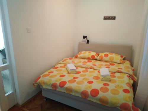 a bedroom with a bed with two phones on it at Holiday Home Vladanka-Planinska kuća Vladanka in Biserske Kuće