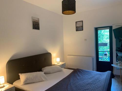 a bedroom with a bed with two pillows and a window at Residence SINAIA Apartments in Sinaia
