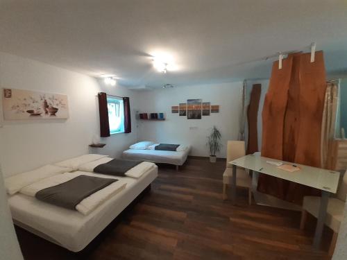 a bedroom with a bed and a table in it at Apartment Riedhof in Fahrenbach