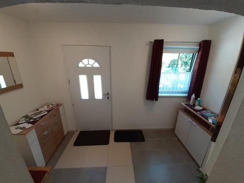 an empty room with a door and a window at Apartment Riedhof in Fahrenbach
