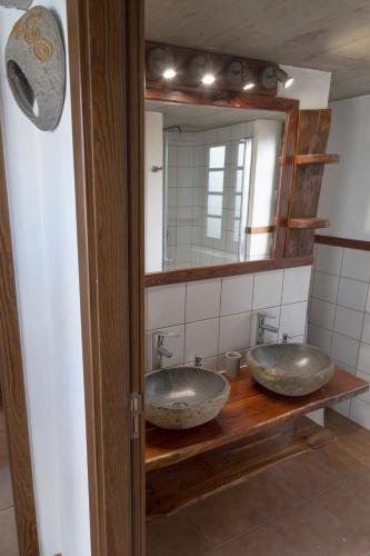 a bathroom with two sinks in front of a mirror at Casa El Llano in Tijarafe