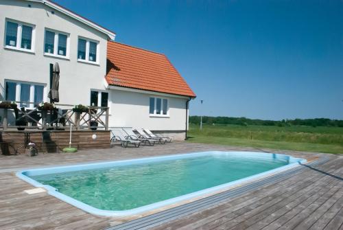 a swimming pool in front of a house at Nordanå Gård in Strö