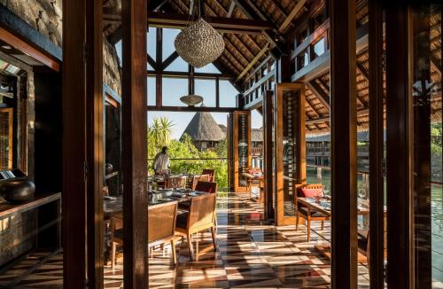 a dining room with a view of the water at Four Seasons Resort Mauritius at Anahita in Beau Champ