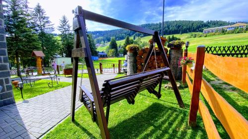 a swing in the yard of a house at Ferienwohnung-direkt-am-Skihang mit Sauna in Kurort Oberwiesenthal