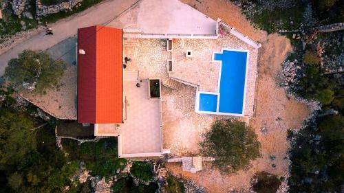 an overhead view of a house with a red and blue roof at Villa Stipanovi Dvori in Vodenjak