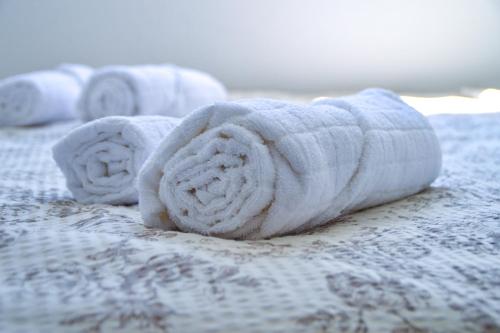 a pile of towels on top of a bed at Apartman “Centar Jajce “ in Jajce