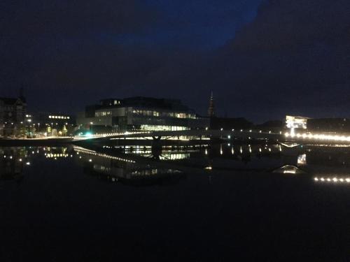 a city at night with a bridge over the water at Hotel CPH Living in Copenhagen