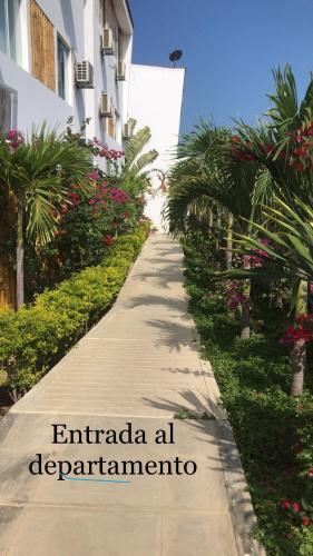 a sidewalk in front of a building with the words emirada at deparna at Las palmeras de bocapan in Tumbes