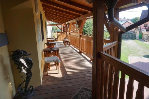 a wooden deck with chairs and a table on it at mlyn-osvracin in Osvračín