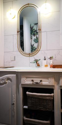 a bathroom with a sink and a mirror at OH ! MADIANA in Saint-Jean-dʼIllac