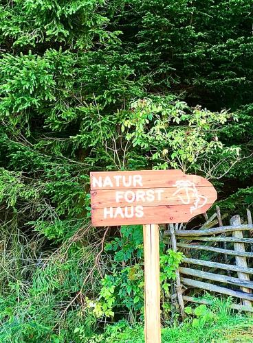 a sign that says nature forest hicks in front of a bush at Naturforsthaus Eddas Zimmer für Hunde - und naturverbundene Menschen in Preitenegg