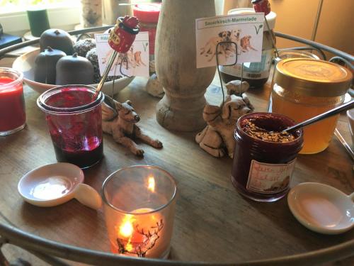 a table with candles and teddy bears and other items at Naturforsthaus Eddas Zimmer für Hunde - und naturverbundene Menschen in Preitenegg