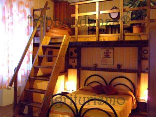 a bedroom with a bunk bed and a staircase at Abbondanza® Agriturismo in Alberobello