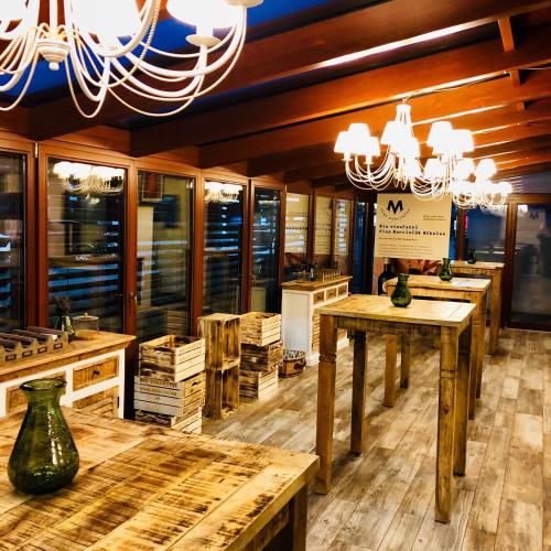 a store with wooden tables and a chandelier at Hotel Marcincak*** in Mikulov