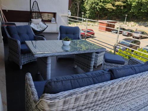 a table and chairs on a balcony with a view of a street at Apartament z tarasem in Wisełka