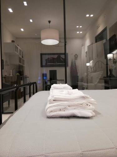 Ein Stapel weißer Handtücher lag auf einem Tisch. in der Unterkunft La suite del centro storico in Matera