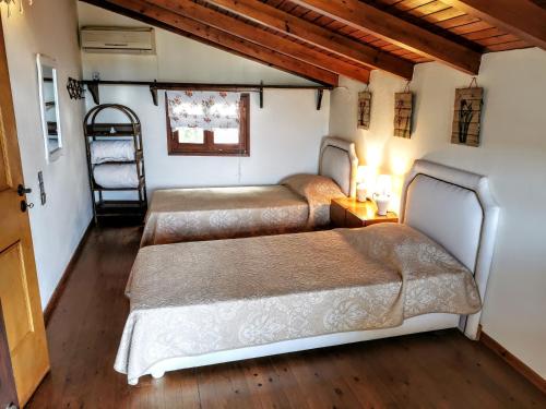 a bedroom with two beds and a ladder at Villa Filiza in Sívas
