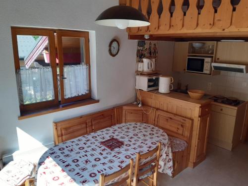 a small kitchen with a table and a table and a table and a table at Les Perthuis - Portes du Soleil in Châtel