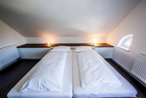 a small room with two beds in it with lights at Achtender in Metzingen
