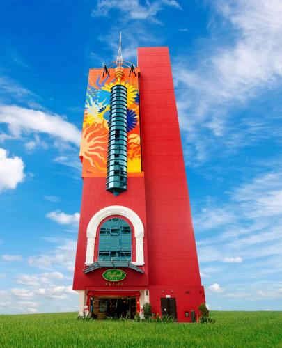 a red building with a painting on it in a field at Oxford Hotel in Singapore