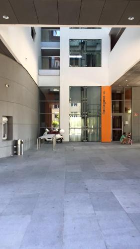 an empty lobby of a building with a table at Sunrise Maribor apartment with private parking in Maribor