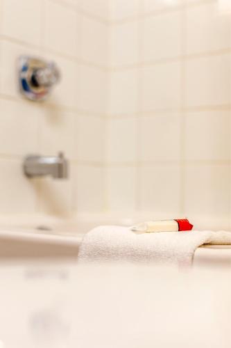 a toothbrush sitting on the edge of a bathroom sink at Super 8 by Wyndham Kamloops On The Hill in Kamloops