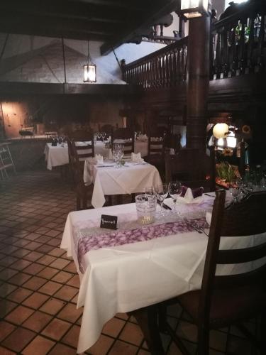 a dining room with tables with white tablecloths at Hotel-Restaurant Bibermühle GmbH in Tengen