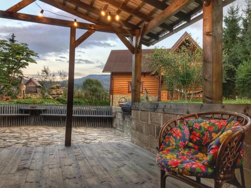 a couch sitting under an umbrella on a patio at SoloMia in Mykulychyn