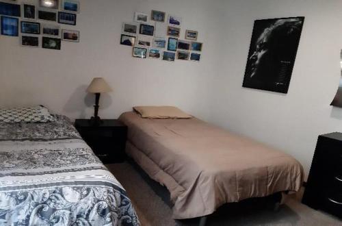 a bedroom with two beds and pictures on the wall at Departamento acogedor para viajeros y turistas in Mexico City