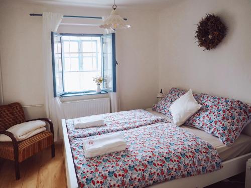a small bedroom with a bed and a window at Chaloupka Pálava in Pavlov