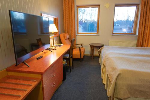 a hotel room with a television and a bed at Tähetorni Hotel in Tallinn