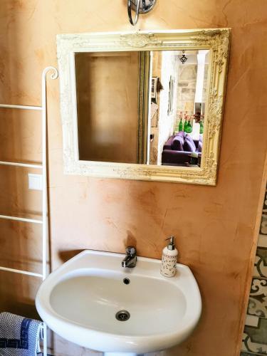 a bathroom with a sink and a mirror at Aelia in Kamilari