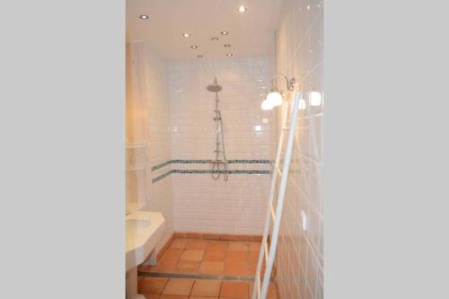 a bathroom with a bath tub and a shower at l'Empereur - La Maïsou in Sérignac
