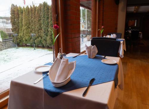 a table with plates and utensils on top of it at Tähetorni Hotel in Tallinn