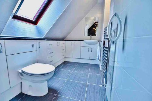 a bathroom with a toilet and a sink at Aldourie Guest House in Fort William