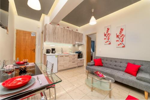 a living room with a couch and a table at Blue Boutique Apts in Amoudara Herakliou