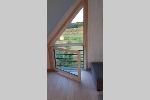 a room with a large window with a view at E Berry Farm - Slow life home in Olszyna